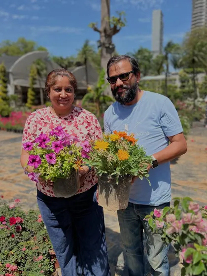 Happiness is buying new plants. This couple is all smiles with their purchase of colorful seasonal flowers.