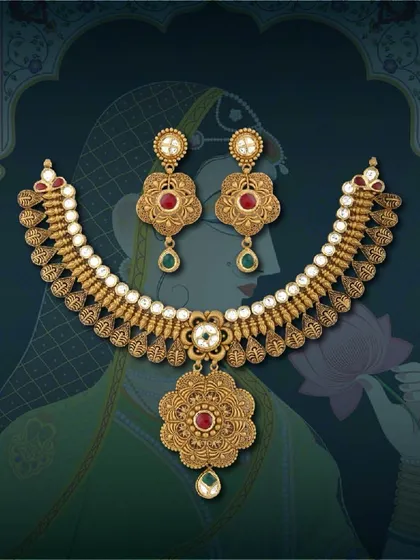 Each piece tells a story. This antique necklace set is adorned with red and green stones, offering a classic design with a touch of colour that appeals to a wide audience.