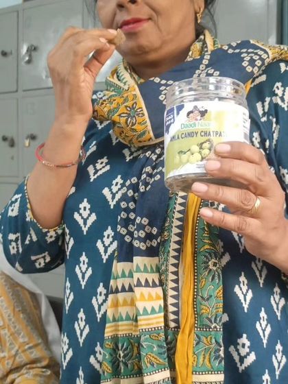 Holding a jar of our Chatpati Amla Candy, this customer is ready to enjoy a tangy treat. Her traditional attire perfectly complements our brand's essence.