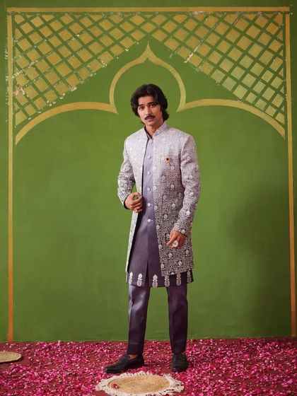 The model strikes a confident pose in the grey Indo-Western suit. The Nazaakat collection is all about blending modern trends with traditional grace.