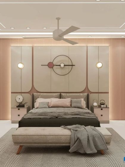 A bedroom with a soft pink and beige color palette, featuring a unique headboard design and a comfortable bench at the foot of the bed.