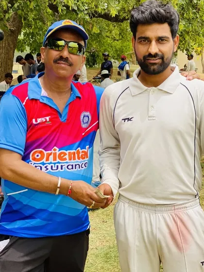 A senior player offering encouragement and a cash prize to a teammate for a great performance. This shows the supportive and motivating culture we foster within the club.
