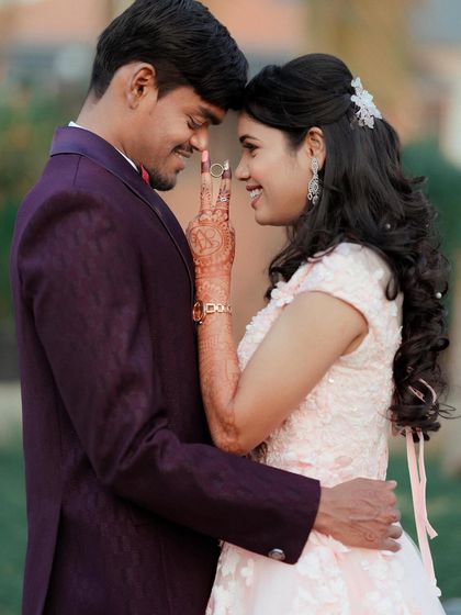 A close-up of the happy moment after the "yes". This couple's joy is perfectly framed, showing off the bride's delicate pink gown and henna.