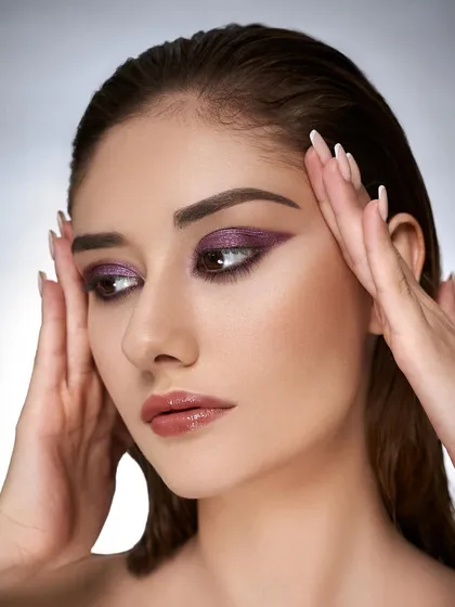 A sharper angle of the purple glitter eye makeup. This shows the precision of the application and the beautiful texture of the glitter on the eyelid.