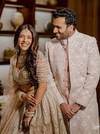 The pure joy of finding your person, reflected in perfectly coordinated style. For their Godh ceremony, we styled the couple in complementary blush pink and beige outfits from Manish Malhotra, full of intricate threadwork and elegant details.