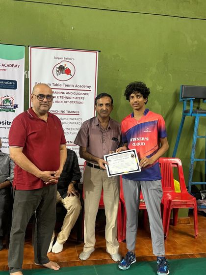 Abhinav K Murthy receiving his certificate after winning a double title in Under 19 Boys Singles and Men's Singles at the Belgaum state ranking tournament.