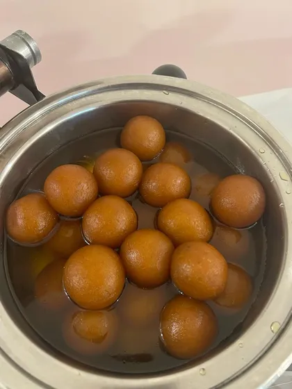 A big bowl of warm, syrupy Gulab Jamuns. This classic Indian dessert is a must-have at any celebration and always leaves guests wanting more.