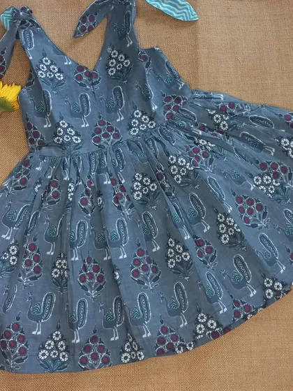 I love incorporating traditional Indian crafts into my designs. This breezy frock features a beautiful block print with birds and flowers, and the tie-up shoulders make it adjustable as your child grows. It's a simple, timeless piece made for sunny days.