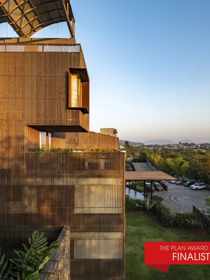 An exterior view of the Radisson Resort, a finalist for The Plan Award 2024, showing how the building's layered facade interacts with the sunlight and surrounding greenery.