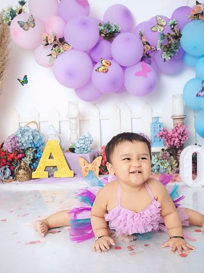 The happiest little butterfly. This colorful first birthday shoot is full of smiles, with a beautiful balloon arch and a playful, celebratory atmosphere.