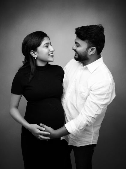 Not just a picture, this is a pause. A quiet black and white moment before everything changes, capturing the love that will soon be redefined by tiny fingers.