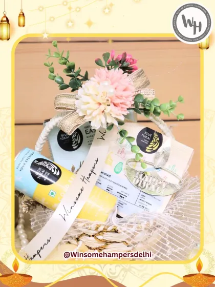 This bright and cheerful hamper features premium Blue Tokai coffee and other gourmet snacks. It's arranged in a lovely basket adorned with artificial flowers and a custom "Winsome Hampers" ribbon, making it a delightful festive surprise.