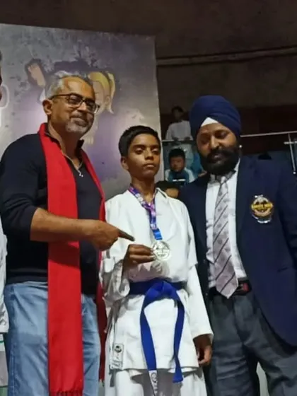 Young champion Shiva being awarded his silver medal at the 2022 National Championship by officials.