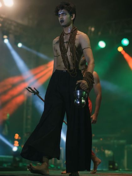 A model channels the spirit of a sadhu on the runway at IIT Roorkee's cultural fest. A creative and conceptual fashion statement captured under dramatic stage lighting.