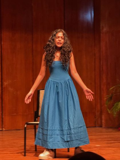 A student delivers a powerful solo performance, capturing the audience with her emotional expression and stage presence.