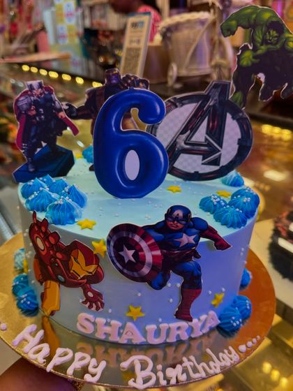 Avengers, assemble! This action-packed cake brings together Iron Man, Captain America, and the Hulk for a 6th birthday celebration. The character toppers and Avengers logo make it a thrilling cake for any young superhero fan.