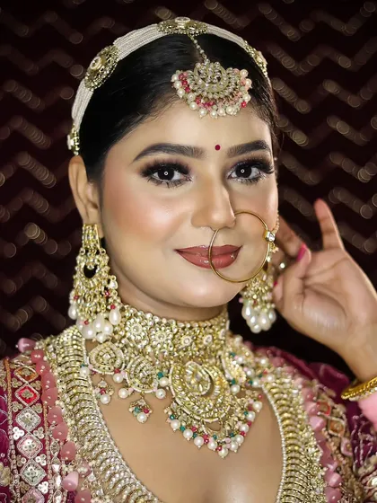A bright and happy bridal portrait. The makeup is flawless, with a focus on creating a look that feels both glamorous and comfortable for the bride on her big day.