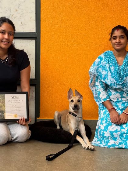 Posing proudly with Mooli and her family. The handler transfer sessions ensure they have the tools to continue her success at home.