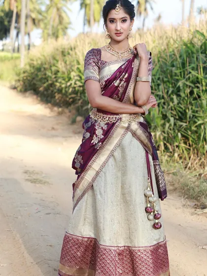 For a timeless South Indian look, I offer this beautiful Langa Voni, or half saree. The elegant combination of cream and deep purple silk is perfect for weddings and festive events.