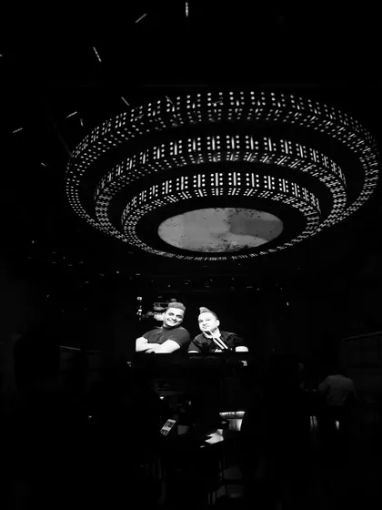 An atmospheric black and white shot from the DJ booth, looking out over the club. This image captures the scale of the venue and the central role I play in orchestrating the night's soundtrack.