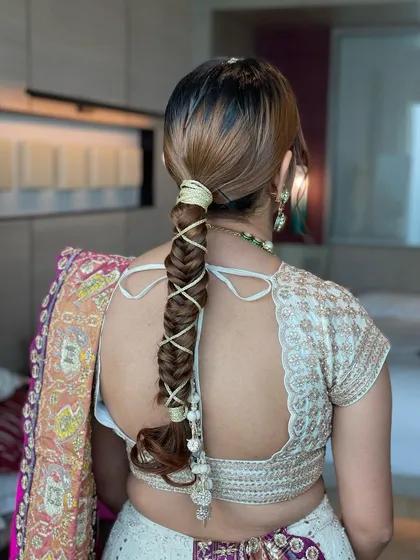 A detailed view of the gotta string braid. This technique keeps the hair neatly tied back while adding a stunning, intricate detail.