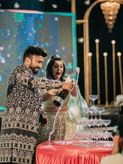 The classic champagne tower, a perfect centerpiece for a glamorous sangeet or reception. It's these moments of celebration and fun that I love to orchestrate for my couples.