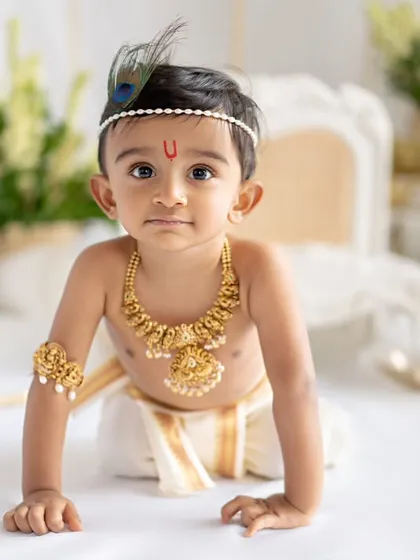 A crawling little Krishna. This pose captures the playful and energetic spirit of the theme.