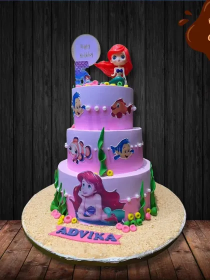 I created this grand, three-tier Little Mermaid cake for a magical fifth birthday. Each layer tells a part of the story, decorated with characters like Ariel and Flounder, edible seaweed, and pearl-like details.