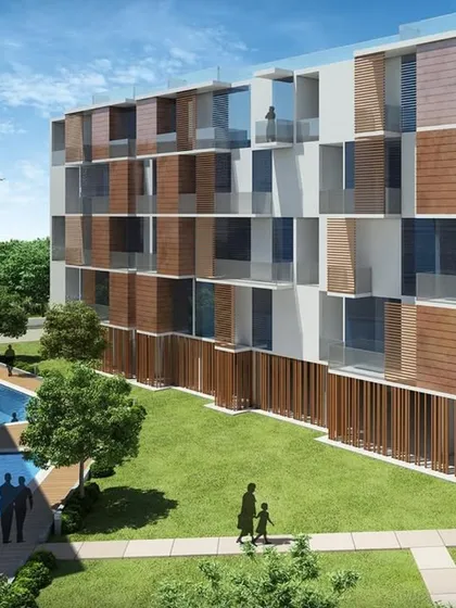 Our projects are seen as small parts of a larger environment. Here, a community pool and lawn provide recreational space while the building's facade incorporates shading elements for passive cooling.