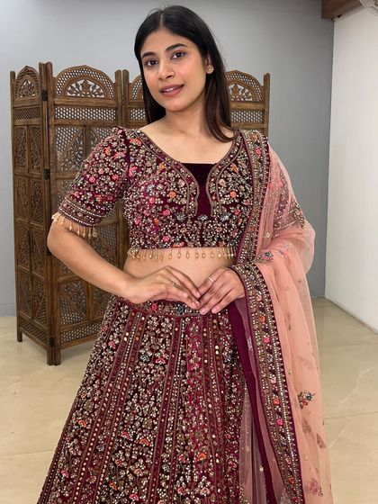 The complete ensemble, showing how the peach dupatta beautifully contrasts with the deep maroon velvet.