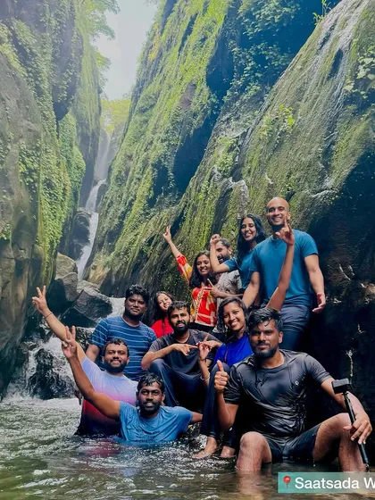 A group of trekkers posing in the beautiful canyon of Saatsada waterfall.