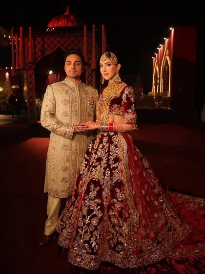 The full grandeur of the bride's reception outfit, complete with a dramatic long veil. The entire look was styled to be a showstopper.