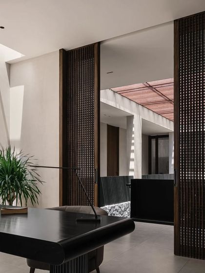 This view from the home office looks out into the central courtyard, reinforcing the home's strong indoor-outdoor connection. The slatted screens provide both visual interest and a sense of enclosure.