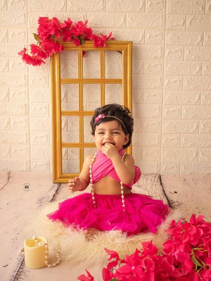 A candid shot of her enjoying a little treat during her birthday session. Her joyful expression is absolutely infectious.