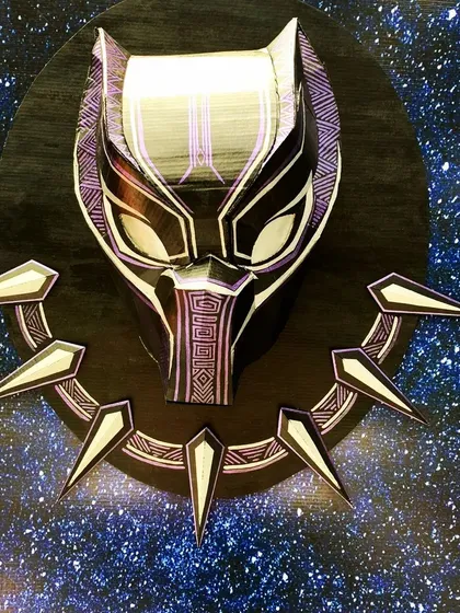 For the superhero fans, I create detailed pieces that capture their favorite characters. This Black Panther mask and necklace was crafted from layered cardboard and set against a galaxy backdrop, making it a powerful centerpiece for an action-packed party.