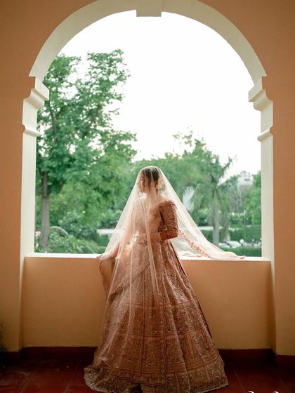 This is that dreamy, Pinterest-perfect bridal portrait. The soft veil and elegant silhouette are complemented by timeless makeup.