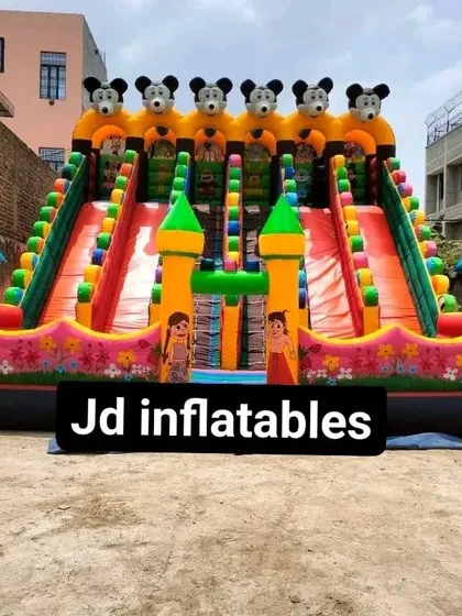 A full view of the 6-slider bouncy castle, showcasing the detailed character artwork along the front. This is a premium model for commercial use in amusement parks.