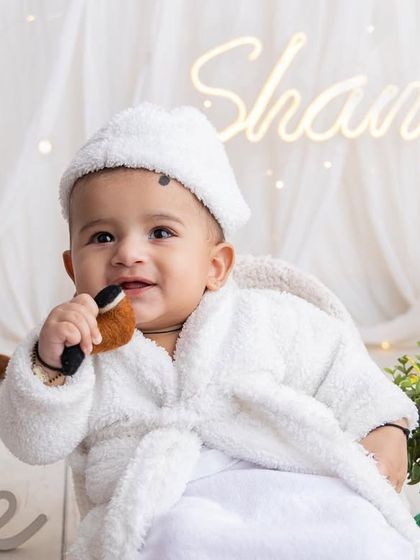 A moment of pure cuteness during this sitter milestone session. The all white setup with soft lighting puts all the focus on his adorable smile and happy personality. These sessions are perfect for babies who can sit up.