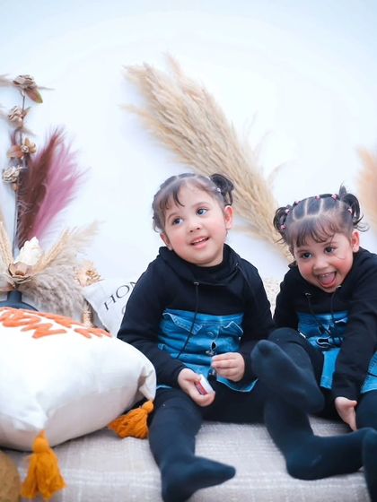 More smiles and fun from our twin photoshoot. We ensure the session is a playful experience for everyone.