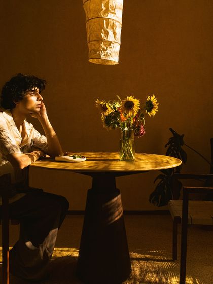 A guest lost in thought in a sunlit corner, a moment of peace that we strive to create.