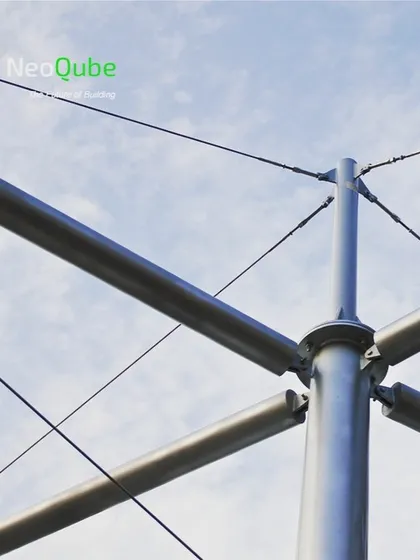 A close-up of the engineering behind our tensile structures. This image shows the steel mast, connection points, and tension cables that form the backbone of a durable and elegant cable-supported membrane canopy.