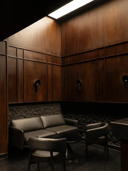 Another view of the private lounge, showing the comfortable seating and the dramatic skylight. This space is designed for quiet conversations and exclusive gatherings.