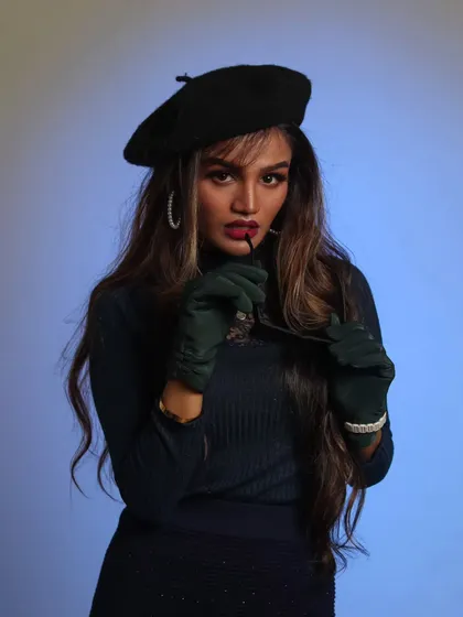 A highly stylized, vintage-inspired studio portrait. The use of accessories like the beret, gloves, and sunglasses, combined with dramatic blue lighting, creates a high-fashion, editorial look that tells a story.