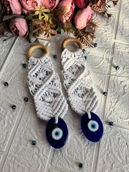 A top-down view of the evil eye wall hangings, showing the detailed knot work and the smooth wooden ring.