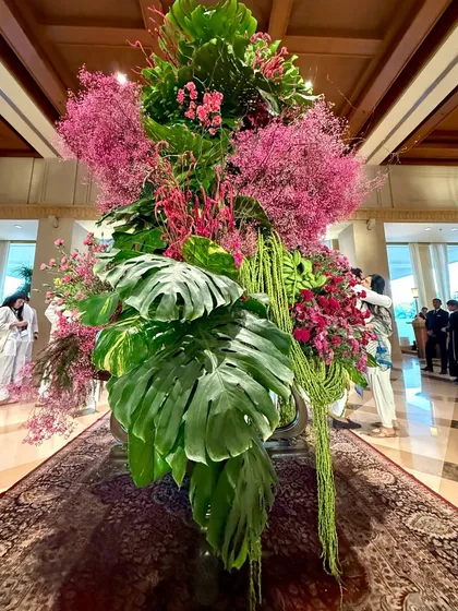 Another view of the tropical pink installation, showing how it commands the center of the lobby. The scale and volume are essential to creating an immersive experience that redefines the entire atmosphere of the space.