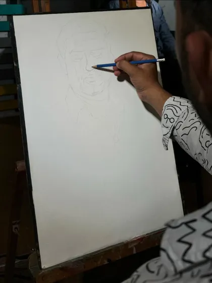 The initial pencil drawing on the paper, the first step of any portrait.