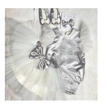 A closer look at the silver and white newborn romper set, a perfect outfit for a baby's first photoshoot or naming ceremony.