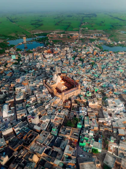 An aerial view of Nandgaon, the village of Krishna's foster father. This drone shot shows the Nand Bhavan temple at the heart of the town, surrounded by a dense network of homes.