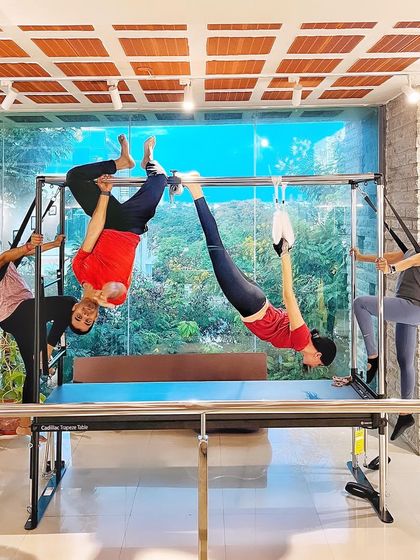 A superhero scene from our studio. This fun, multi person pose on the Cadillac shows the playful and supportive atmosphere we cultivate.