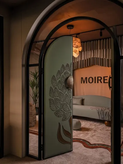 The entrance sets the tone for the entire experience. We designed this arched door to be a statement of intent, wrapping it in a custom-embellished fabric with a 3D floral motif. It’s a tactile invitation that signals this is no ordinary boutique.